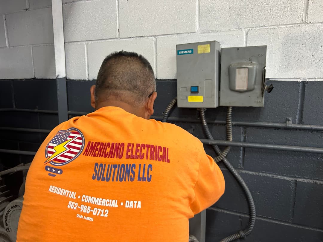 Electrician working on Siemens electrical panel at Americano Electrical Solutions LLC.